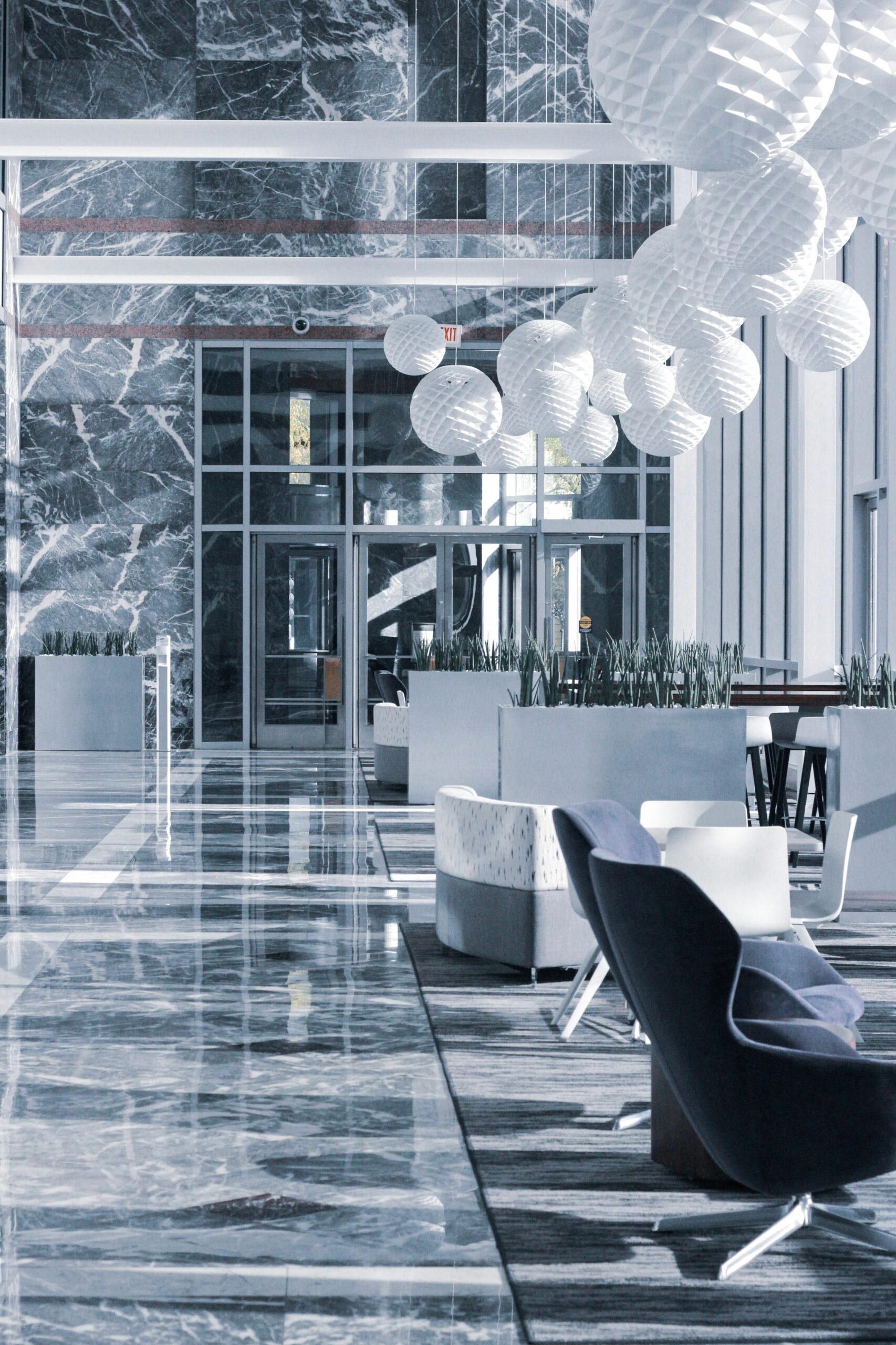 Elegant hotel lobby with marble floors and modern furniture design.
